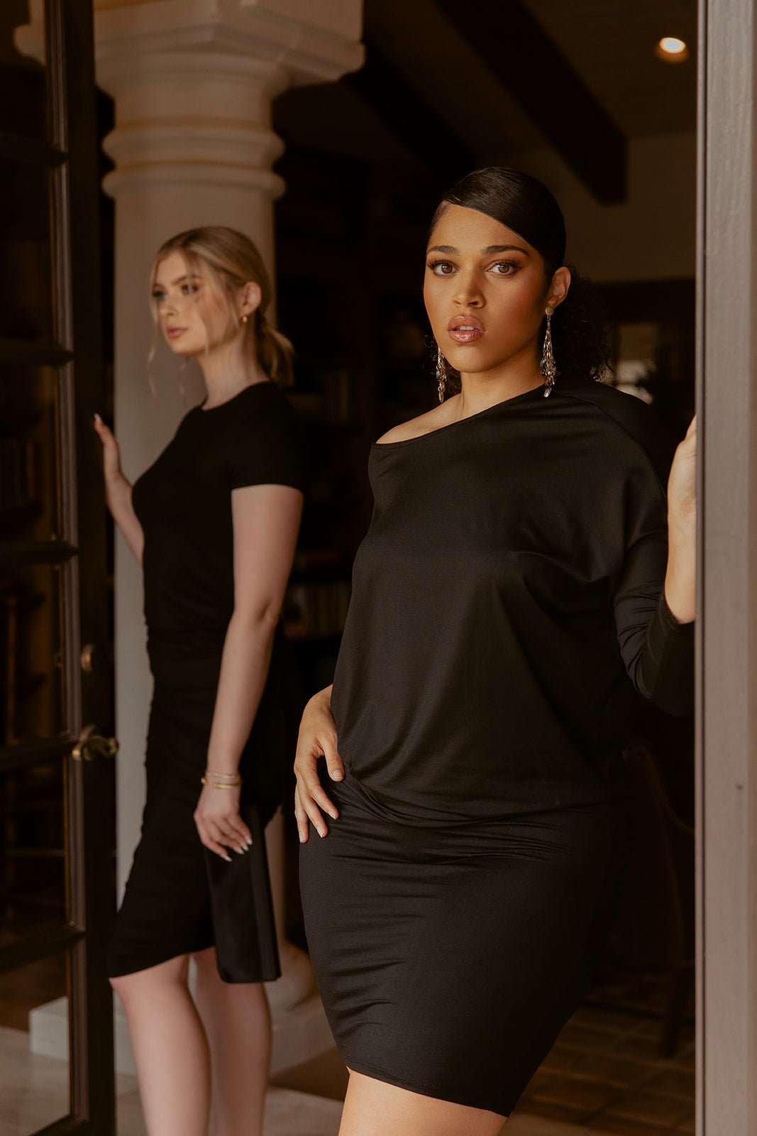 Bodywear and Bodysuits - Adea - Everyday Luxury.  Versatile Wedge Dress in black shown on models in luxury setting.