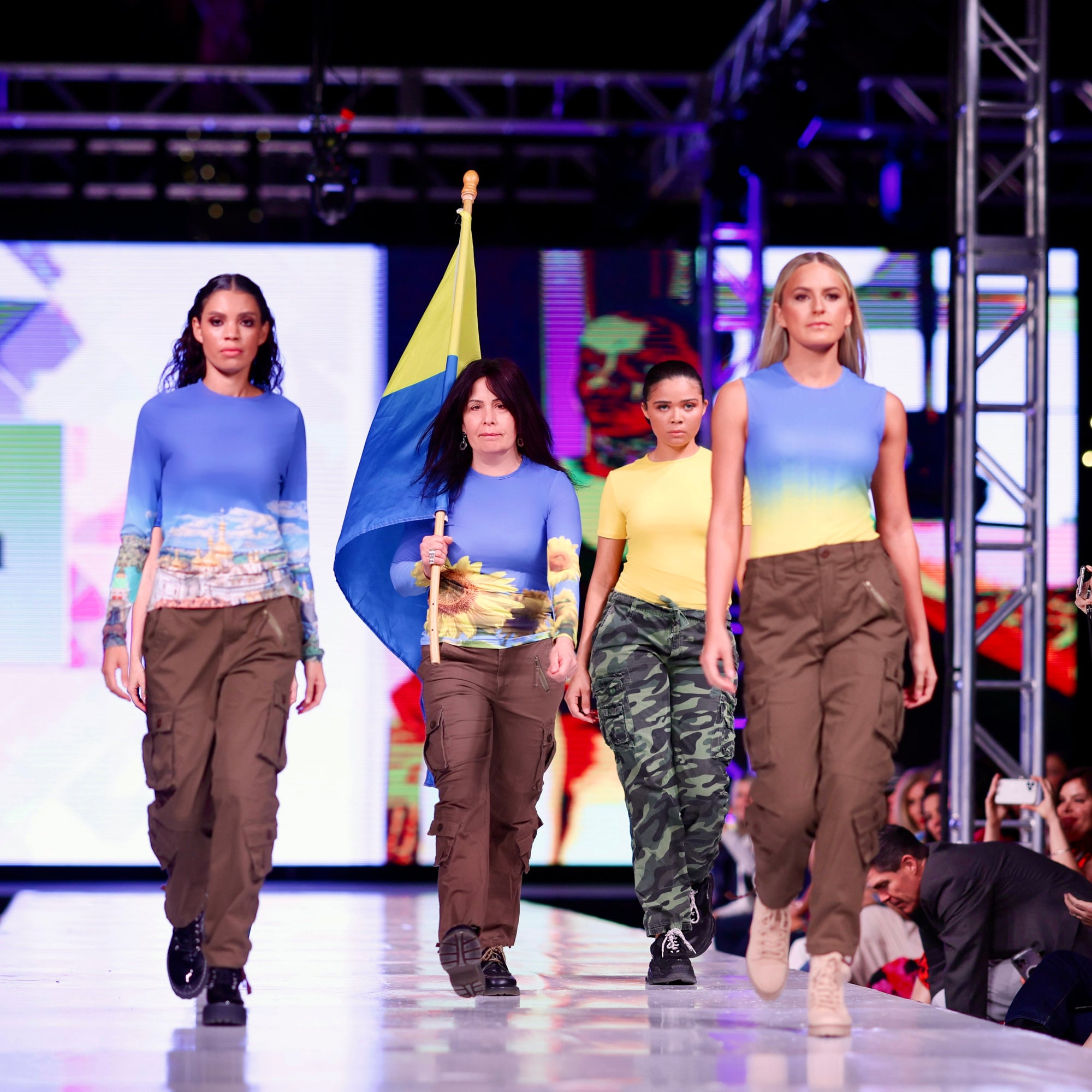 On the runway at Phoenix Fashion Week April 2022.  Adea has created a collection honoring Ukraine.  $25 from every top sold is donated to USA for UNHCR.  Designs include the national sunflower, the Kyiv Pechersk Lavra and the colors of the flag. 