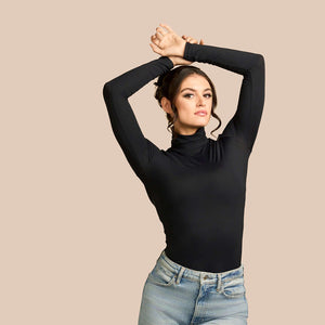 Long Sleeve Turtleneck Luxury Layering Top or Shell in Black made sustainably in the USA by Adea Clothing with silky Italian fabric fun pose with jeans.