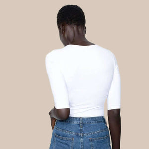 Close-up of breathable Italian microfiber on a white Adea 3/4 sleeve crew neck top. Back view.